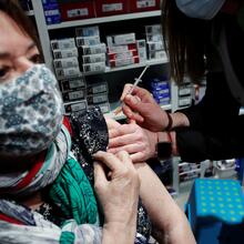 A pharmacist administers the AstraZeneca Covid-19 vaccine to a patient in a pharmacy in Paris on March 19, 2021. (CNS photo/Benoit Tessier, Reuters)