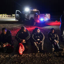 Migrants wait to be processed after crossing the border on Jan. 6, 2023, near Yuma, Ariz. The Biden administration says it will generally deny asylum to migrants who show up at the U.S. southern border without first seeking protection in a country they passed through. (AP Photo/Gregory Bull, File)