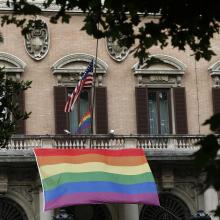 Rainbow flags fly alongside the U.S. flag outside the U.S. Embassy to Italy in Rome June 16. A prayer service was held nearby at St. Patrick's Catholic Church in remembrance of the victims of the Orlando, Fla., terrorist attack (CNS photo/Paul Haring).