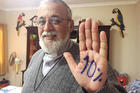 Camillian Father Mateo Bautista Garcia shows his hand with "10%" written on it. The priest wants Bolivia's government to spend 10 percent of its budget on health care. (CNS photo/David Agren)