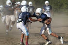 Player attempts to make tackle during football practice at Maryland Catholic high school. (CNS photo /Bob Roller)