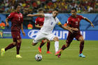 Dempsey of U.S. attempts to score between Portugal's Alves and Costa during World Cup soccer match. (CNS photo/Jorge Silva, Reuters)