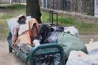 A homeless man rests on a bench in a park outside St. Vincent de Paul Church in downtown Baltimore. (CNS photo/Bob Roller) 