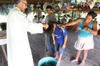 Augustinian Father Miguel Angel Cadenas baptizes a young man June 12, in a village along the Urituyacu River in Peru.