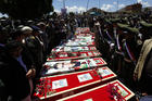 Yemeni mourners gather beside the coffins of the victims of recent suicide attacks during a funeral in Sana'a, Yemen, March 25. (CNS photo/Yahya Arhab, EPA) 