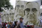 People carry large portraits of Salvadoran Archbishop Oscar Romero during rally in his honor in San Salvador (CNS photo/Roberto Escobar, EPA)