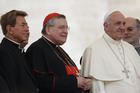 U.S. Cardinal Raymond L. Burke, patron of the Knights and Dames of Malta, center left, and a group of priests pose with Pope Francis during his general audience in St. Peter's Square at the Vatican Sept. 2. (CNS photo/Paul Haring)