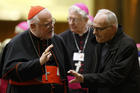  Cardinal Reinhard Marx of Munich-Freising, president of the German bishops' conference, talks with an unidentified delegate as they leave the final session of the Synod of Bishops on the family at the Vatican Oct. 24. (CNS photo/Paul Haring) 