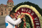 A man adjusts the crown on a statue of Our Lady of Guadalupe Dec. 6 outside the basilica named for her in northern Mexico City. The national patroness remains important in Mexico as source of spiritual inspiration, but even nonoreligious people identify with her. (CNS photo/David Agren)