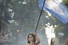 A girl carries an Argentine flag during a rally on President Cristina Fernandez de Kirchner's last day in office Dec. 10. (CNS photo/Paul Jeffrey) 