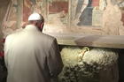 Pope Francis prays in front of a Nativity scene during a Jan. 4 surprise visit to the Franciscan shrine in Greccio, Italy. (CNS photo/L'Osservatore Romano, handout via EPA)