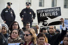 A man displays a sign as immigration advocates rally outside the U.S. Supreme Court Jan. 15, 2016, in Washington. (CNS photo/Michael Reynolds, EPA)