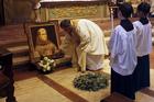 Father Miguel Rodriguez sets a relic on the tomb of St. Junipero Serra during Mass at the Carmel Mission Basilica in Carmel, Calif., Sept. 23, 2016, the day the Spanish missionary and founder of the California mission system was cannonized by Pope Francis in Washington. (CNS photo/Michael Fiala, Reuters)