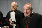 Cardinal Lorenzo Baldisseri, general secretary of the Synod of Bishops, and Austrian Cardinal Christoph Schonborn, holds a copy of Pope Francis' apostolic exhortation on the family, "Amoris Laetitia" ("The Joy of Love"), during a news conference for the document's release at the Vatican April 8, 2016. The exhortation is the concluding document of the 2014 and 2015 synods of bishops on the family. (CNS photo/Paul Haring)