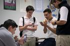 Students at St. Joseph Academy in Brownsville, Texas, check their smartphones during lunch May 3. (CNS photo/Tyler Orsburn)