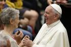 Pope Francis laughs as he greets a woman during an audience with people from Lyon, France, in Paul VI hall at the Vatican July 6. The audience was with 200 people living in difficult or precarious situations. (CNS photo/Paul Haring) 