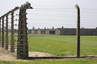 A barbed wire fence frames the prisoners' barracks on July 25 at the Birkenau Nazi concentration camp in Oswiecim, Poland. (CNS photo/Bob Roller)
