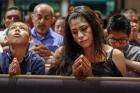 Xavier Albarran, 9, and his mother, Erika Albarran, pray during the Litany of Saints at a Mass celebrated July 27 by Bishop David R. Choby of Nashville, Tenn. (CNS photo/ Rick Musacchio, Tennessee Register)