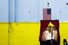 A woman enters a voting booth in Hoboken, N.J., June 7. (CNS photo/Justin Lane, EPA) 