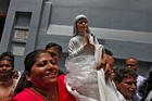 A woman holds a statuette of Mother Teresa outside the Missionaries of Charity building in Kolkata, India, Sept. 4. (CNS photo/Rupak De Chowdhuri, Reuters)