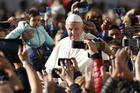 People take photos on smartphones as Pope Francis greets the crowd during his general audience in St. Peter's Square at the Vatican Oct. 12. (CNS photo/Paul Haring) 