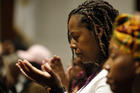 A woman prays during a healing Mass on Nov. 12, 2016, at St. Martha Church in Uniondale, N.Y. The liturgy was celebrated in observance of National Black Catholic History Month. (CNS photo/Gregory A. Shemitz)