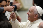  Pope Francis touches a rosary during his general audience in Paul VI hall at the Vatican Nov. 30. (CNS photo/Paul Haring) 