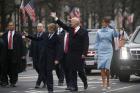 U.S. President Donald Trump and first lady Melania Trump wave as they walk with their son, Barron, along Pennsylvania Avenue during the Jan. 20 inaugural parade from the U.S. Capitol in Washington. (CNS photo/Jonathan Ernst, Reuters) 