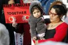 Victoria Daza, a native of Peru and an immigrants' rights activist, holds her daughter during a rally in support of immigrants in Massapequa Park, N.Y., Feb. 24. (CNS photo/Gregory A. Shemitz)