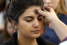 A woman receives ashes during Ash Wednesday Mass