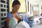 A mother feeds her child as she waits outside of a SAMAN nutrition clinic in Caracas, Venezuela. (CNS photo/Cody Weddle, GSR)