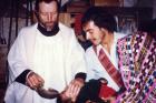 Father Stanley Rother, a priest of the Oklahoma City Archdiocese who was brutally murdered in 1981 in the Guatemalan village where he ministered to the poor, is shown baptizing a child in this undated photo. (CNS) 