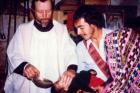 Father Stanley Rother, a priest of the Oklahoma City Archdiocese who was brutally murdered in 1981 in the Guatemalan village where he ministered to the poor, is shown baptizing a child in this undated photo. The Archdiocese of Oklahoma City announced the North American priest will be beatified on Sept. 23 in Oklahoma. (CNS)