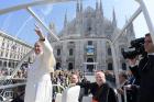 Pope Francis is accompanied by Cardinal Angelo Scola of Milan as he greets the crowd outside the cathedral in Milan March 25. (CNS photo/L'Osservatore Romano)