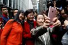 Women take selfies with Carrie Lam on March 27, the day after she was elected Hong Kong's Chief Executive. Lam was chosen as Hong Kong's new leader in the first such vote since 2014, when pro-democracy protests erupted over the semi-autonomous Chinese city's election system. (CNS photo/Tyrone Siu, Reuters)