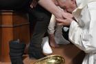 Pope Francis kisses the foot of an inmate April 13 at Paliano prison outside of Rome as he celebrates Holy Thursday Mass of the Lord's Supper. The pontiff washed the feet of 12 inmates at the maximum security prison. (CNS photo/L'Osservatore Romano)