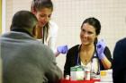 Angelica Italiano and Brighid Imperiale, first-year students at the Philadelphia College of Osteopathic Medicine, screen patients on March 5 at St. Patrick Parish's church hall in Norristown, Pa. (CNS photo/Sarah Webb, CatholicPhilly)