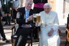 Retired Pope Benedict XVI enjoys a beer during his his 90th birthday celebration April 17 at the Vatican. (CNS photo/L'Osservatore Romano)