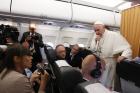 Pope Francis listens to a question from Vera Shcherbakova of the Itar-Tass news agency while talking with journalists aboard his flight from Cairo to Rome April 29. (CNS photo/Paul Haring) 