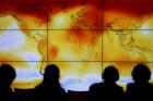 Participants look at a screen showing a world map with climate anomalies during the World Climate Change Conference at Le Bourge, France, in this Dec. 8, 2015, file photo. (CNS photo/Stephane Mahe, Reuters)