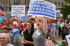  People display signs showing their support for religious freedom during a 2012 rally in downtown Minneapolis. It has been 20 years since the International Religious Freedom Act was passed by Congress and became law. (CNS photo/Dave Hrbacek, The Catholic Spirit)