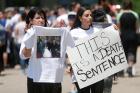 Chaldean-Americans protest on June 12 outside Mother of God Chaldean Catholic Church in Southfield, Mich., after dozens of Chaldean Christians were arrested by federal immigration officials over the weekend of June 10 and 11 in the Detroit metropolitan area. (CNS photo/Rebecca Cook, Reuters) 