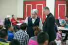 Sister Norma Pimentel, executive director of Catholic Charities of the Rio Grande Valley, and Cardinal Blase J. Cupich of Chicago greet asylum seekers at the Humanitarian Respite Center at Sacred Heart Church in McAllen, Texas, on Aug. 15. (CNS photo/courtesy Catholic Extension)