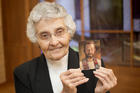 Sister Marita Rother, a member of the Adorers of the Blood of Christ, holds a picture of her brother, Father Stanley Rother, a priest of the Oklahoma City Archdiocese, who will be beatified on Sept. 23 in Oklahoma City. (CNS photo/Christopher Riggs, Catholic Advance)