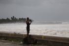 A man in Nagua, Dominican Republic, takes a photo of the Caribbean Sea on Sept. 7 as Hurricane Irma moves toward Florida. (CNS photo/Ricardo Rojas, Reuters)