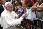 Pope Francis greets people near the Talitha Qum homeless shelter in Cartagena, Colombia, Sept. 10. The pope cut his head in the popemobile when it braked suddenly. (CNS photo/Paul Haring) 