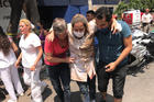 An injured woman is assisted in Mexico City on Sept. 19 after a magnitude 7.1 earthquake hit to the southeast of the city, killing hundreds. (CNS photo/Carlos Jasso, Reuters)