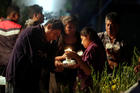 People light candles on Sept. 20 for the 11 victims who died after the roof of a church collapsed following an earthquake in Atzala, on the outskirts of Puebla, Mexico. A Catholic bishop and a Caritas worker in Mexico said the situation was extremely serious after the Sept. 19 earthquake, and much aid would be needed. (CNS photo/Imelda Medina, Reuters)