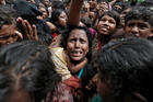 Rohingya refugees wait to receive aid Sept. 21 at a camp in Cox's Bazar, Bangladesh. (CNS photo/Cathal McNaughton, Reuters)