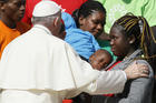 Pope Francis greets immigrants and representatives of Caritas Internationalis during his general audience in St. Peter's Square at the Vatican Sept. 27. (CNS photo/Paul Haring)